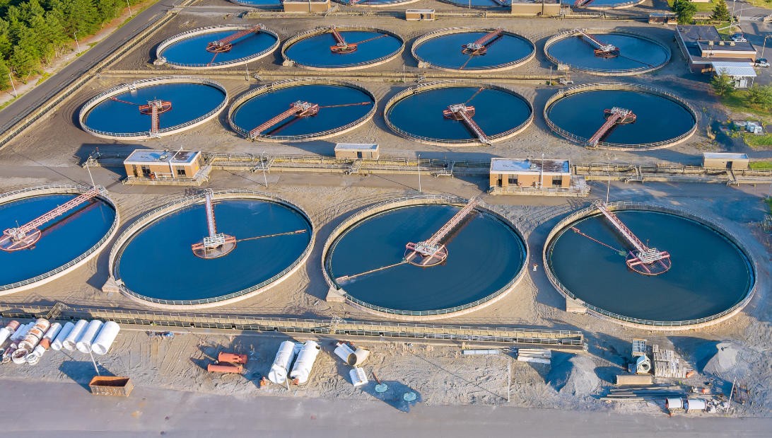 Aerial view of circular treatment tanks and connecting infrastructure.